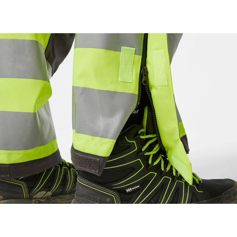 Ielādējiet attēlu galerijas skatītājā, Puskombinezons HELLY HANSEN ALNA 2.0 Hi Vis Waterproof Shell Construction Class 2 71493
